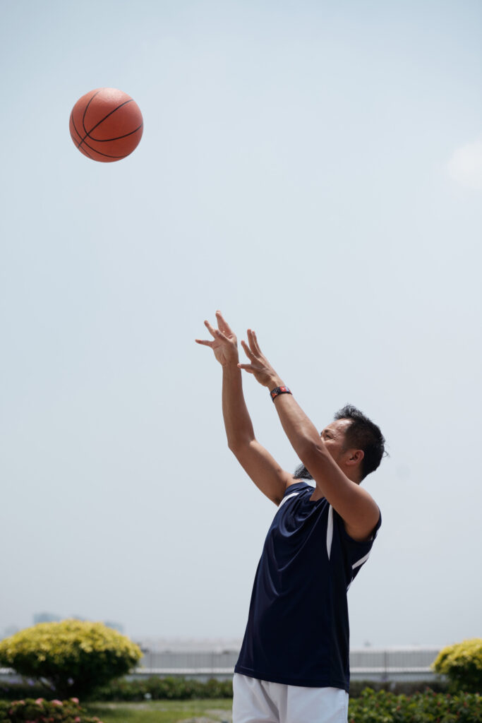 man standing shooting a ball